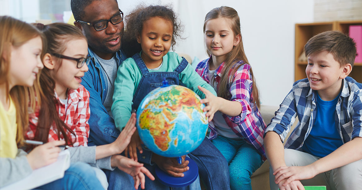 Globe with teacher and students